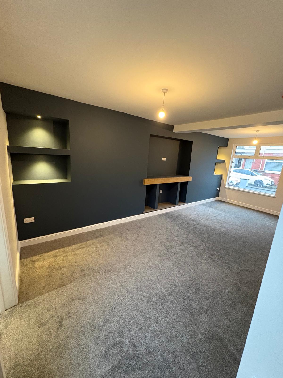 Finished living room with built-in alcove shelving